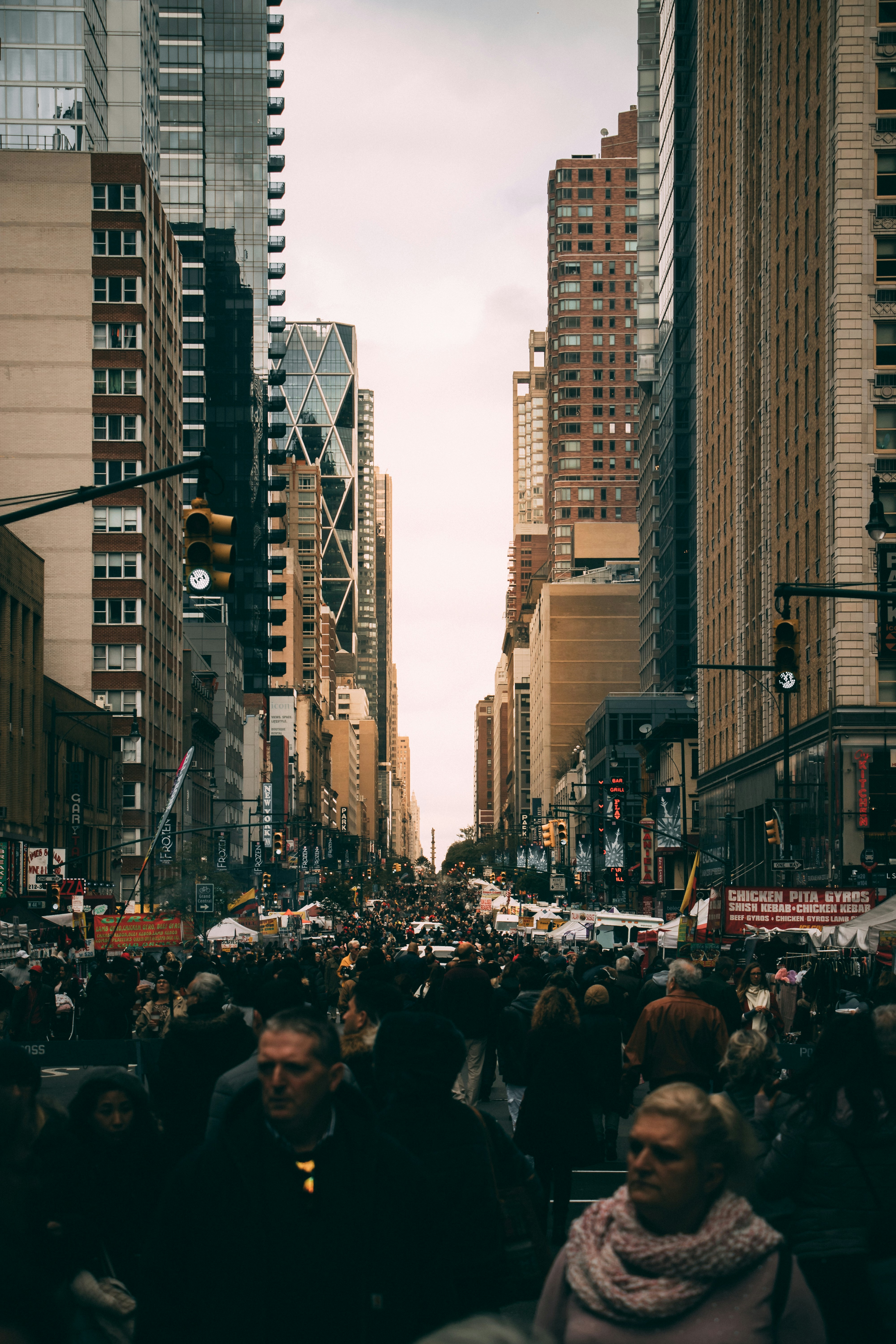 Crowded urban street scene surrounded by high-rise buildings, illustrating the impact of rapid population growth and dense urbanization on climate vulnerability and environmental sustainability.