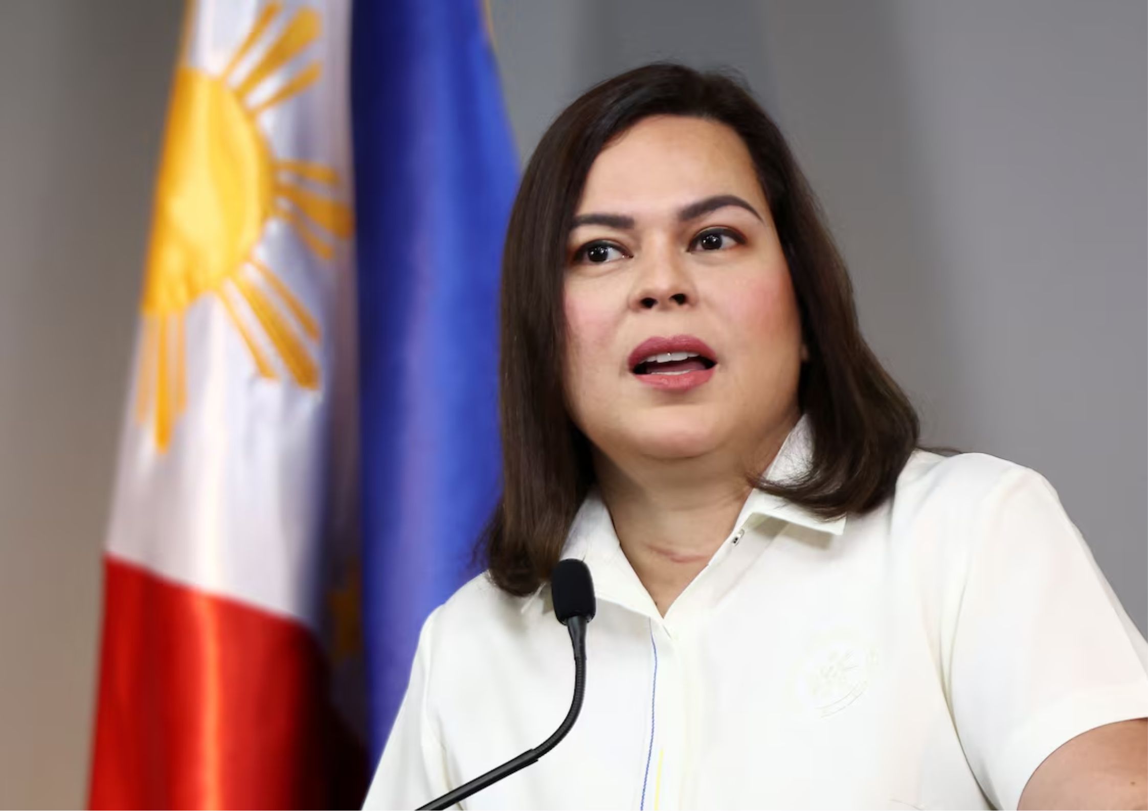 Sara Duterte delivers a speech with the Philippine flag in the background, symbolizing her rising leadership and nationalist rhetoric.