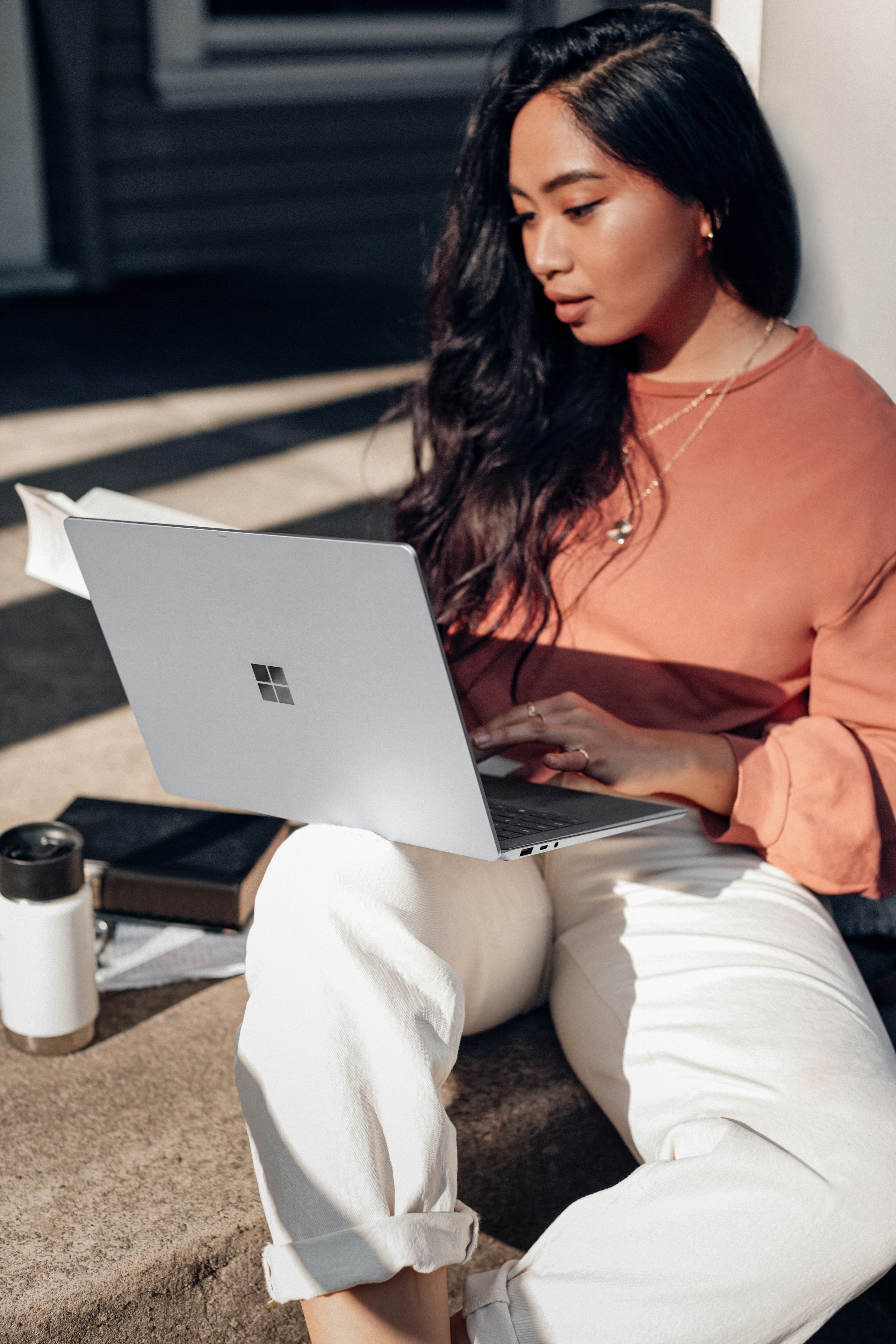Young Filipino woman using laptop to challenge online disinformation and engage in digital activism